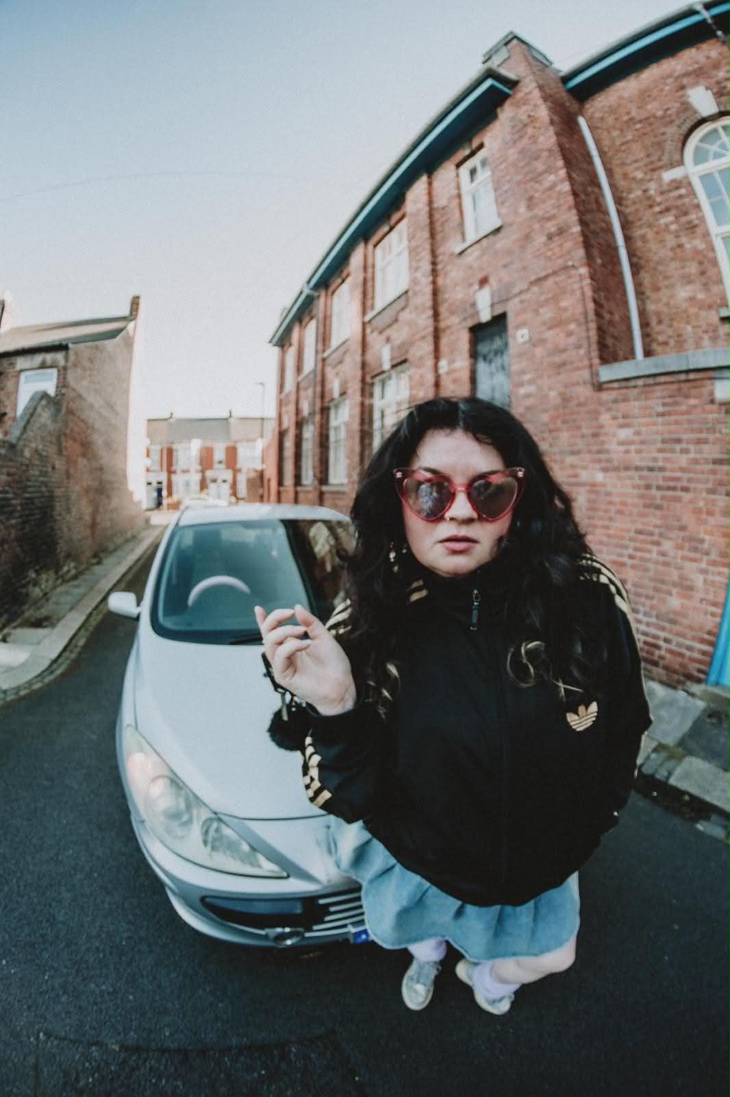 Roisin Crowley Linton posing in front of a car.