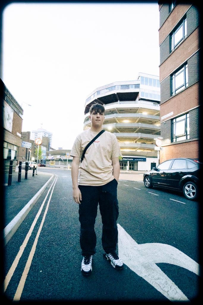 Jenks stood in the middle of the road, buildings either side and behind him
