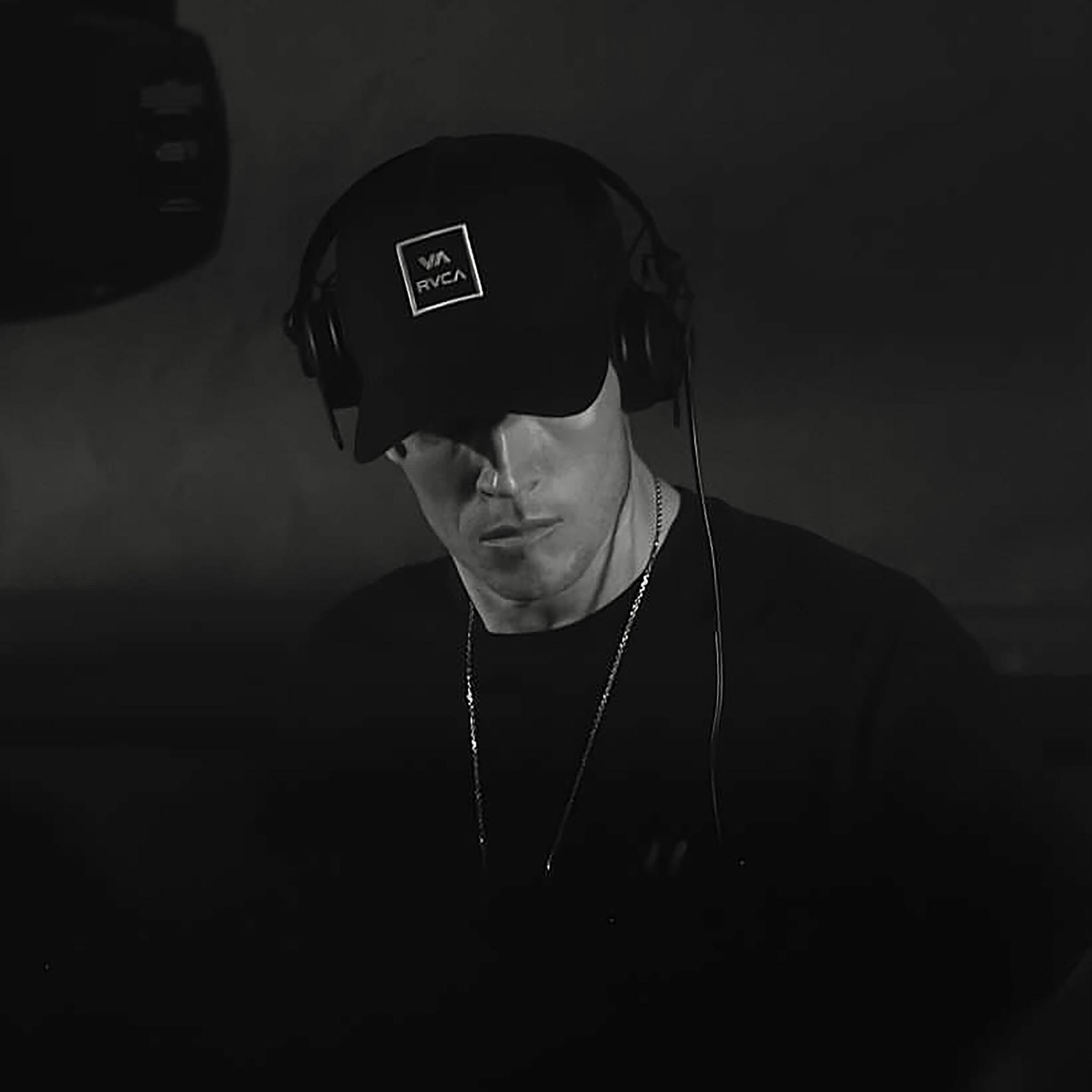 Sonny with a black baseball cap on, looking towards the floor