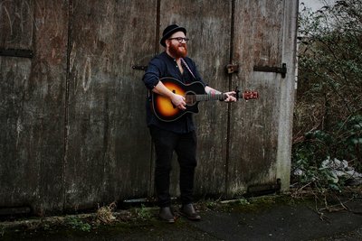 Sam Eason playing his guitar.